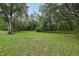 Sprawling backyard with mature trees and a peaceful, natural setting at 2180 Captain Dr, Deltona, FL 32738