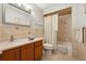 This well-lit bathroom features a shower over tub and vanity sink with a wood cabinet at 2180 Captain Dr, Deltona, FL 32738