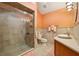 Well-lit bathroom features a glass-door shower, tile surround, and a stylish vessel sink at 2180 Captain Dr, Deltona, FL 32738