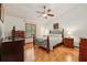 Cozy bedroom features a wood-look floor, ceiling fan and natural light from the window at 2180 Captain Dr, Deltona, FL 32738
