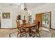 Warm dining area with a wooden table, tile flooring, and access to a patio at 2180 Captain Dr, Deltona, FL 32738