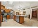 Modern kitchen boasting stainless steel appliances, an island with a sink, and tile flooring at 2180 Captain Dr, Deltona, FL 32738