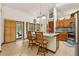 Bright kitchen featuring an island with bar seating, stainless steel appliances, and tile floors at 2180 Captain Dr, Deltona, FL 32738