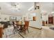 Open-concept living and dining area featuring tile floors, a wooden table, and lots of natural light at 2180 Captain Dr, Deltona, FL 32738