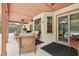 Covered patio provides a comfortable outdoor living space with wicker furniture and ceiling fans at 2180 Captain Dr, Deltona, FL 32738