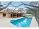 Large screened-in pool area with attached spa, surrounded by a spacious patio at 2180 Captain Dr, Deltona, FL 32738