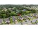 Areal view of a single-story home with brick driveway, well-maintained lawn, and lush trees in the distance at 2339 Jernigan Loop, Kissimmee, FL 34746