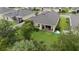 Aerial view of backyard patio with grill, manicured lawn, partial fence and an above ground pool at 2339 Jernigan Loop, Kissimmee, FL 34746