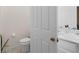 Half bathroom showcases a toilet and sink with neutral paint at 2339 Jernigan Loop, Kissimmee, FL 34746