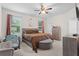 Well-lit bedroom with neutral tones, a ceiling fan, and plenty of natural light at 2339 Jernigan Loop, Kissimmee, FL 34746