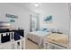 Bright bedroom with coastal decor, a large window, and comfortable furnishings at 2339 Jernigan Loop, Kissimmee, FL 34746