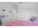 A cozy bedroom features a pink fuzzy blanket and a cute stuffed-animal-filled chair at 2339 Jernigan Loop, Kissimmee, FL 34746