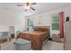 Bedroom featuring a queen bed, grey storage ottoman, and modern decor at 2339 Jernigan Loop, Kissimmee, FL 34746