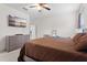 Bedroom with warm brown bedding, a television, and natural lighting at 2339 Jernigan Loop, Kissimmee, FL 34746