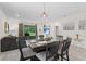 Cozy dining area with elegant table setting, flowing into the living room, and lots of natural light at 2339 Jernigan Loop, Kissimmee, FL 34746