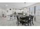 Bright dining area featuring modern table setting, white cabinets, and contemporary lighting fixtures at 2339 Jernigan Loop, Kissimmee, FL 34746