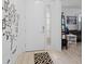 Bright entryway with decorative tree decals, neutral tile flooring, and a stylish patterned rug at 2339 Jernigan Loop, Kissimmee, FL 34746