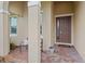 Inviting front porch with brick pavers, decorative columns, and a cozy bench, perfect for relaxing at 2339 Jernigan Loop, Kissimmee, FL 34746