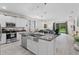 Open kitchen featuring stainless appliances, granite counters and a large island with a stainless sink at 2339 Jernigan Loop, Kissimmee, FL 34746
