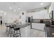Bright kitchen featuring a granite island with bar stools, stainless steel appliances, and sleek white cabinets at 2339 Jernigan Loop, Kissimmee, FL 34746