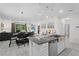 Bright kitchen featuring a breakfast bar, stainless steel appliances, and an open floor plan at 2339 Jernigan Loop, Kissimmee, FL 34746