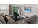 Comfortable living room with plush seating, neutral tones, and a view of the backyard at 2339 Jernigan Loop, Kissimmee, FL 34746