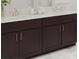 Bathroom vanity with dark cabinetry, light countertops, and modern fixtures at 3021 Namaste Dr, Clermont, FL 34714