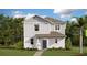 Charming two-story home featuring board and batten siding, complemented by lush landscaping and a well-manicured lawn at 3021 Namaste Dr, Clermont, FL 34714
