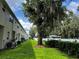 Green backyard with a white fence bordering the townhome properties, providing a private outdoor space at 3118 Crown Jewel Ct, Winter Park, FL 32792