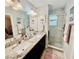 Bathroom featuring double sinks, granite countertops, and a glass-enclosed shower at 3118 Crown Jewel Ct, Winter Park, FL 32792