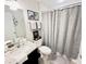 Bathroom featuring granite sink, decorative towels, and shower with gray curtain at 3118 Crown Jewel Ct, Winter Park, FL 32792