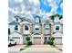 Charming townhomes with brick driveways, dormer windows, and stone facade accents creating curb appeal at 3118 Crown Jewel Ct, Winter Park, FL 32792