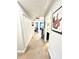 Hallway with carpet, white doors and view into bedroom, bathroom and living area at 3118 Crown Jewel Ct, Winter Park, FL 32792