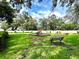Community playground in a grassy area with benches and a colorful play structure at 3118 Crown Jewel Ct, Winter Park, FL 32792