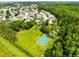 Neighborhood aerial view featuring a basketball court, trees and homes in a suburban community at 3224 Holland Dr, Orlando, FL 32825