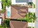 Aerial view of a single-Gathering home with a brown roof, green lawn, mature trees and a fenced pool in the backyard at 3224 Holland Dr, Orlando, FL 32825