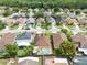 This aerial view showcases a home with a private pool in a lush, tree-lined suburban neighborhood at 3224 Holland Dr, Orlando, FL 32825