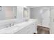 Bathroom featuring white vanity, dual sinks with modern fixtures, and bright lighting at 3224 Holland Dr, Orlando, FL 32825