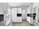 Updated kitchen with granite countertops, white cabinets, and stainless steel refrigerator at 3224 Holland Dr, Orlando, FL 32825