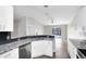 Bright kitchen featuring granite countertops, white cabinets, and modern appliances with access to a patio at 3224 Holland Dr, Orlando, FL 32825