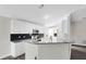 Modern kitchen with granite countertops, white cabinets, and stainless steel appliances at 3224 Holland Dr, Orlando, FL 32825