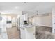 Modern kitchen open to living area, featuring granite counters, white cabinets, and stainless appliances at 3224 Holland Dr, Orlando, FL 32825