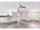 Bright, open-concept living area with modern gray laminate flooring and a neutral color palette at 3224 Holland Dr, Orlando, FL 32825