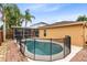 Backyard pool featuring a screened-in lanai, brick pavers and privacy fencing at 3224 Holland Dr, Orlando, FL 32825