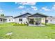 Inviting backyard with lush lawn and a covered patio, perfect for outdoor entertaining at 324 James Pl, St Cloud, FL 34769