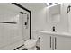 Modern bathroom featuring a stylish glass-enclosed shower and a new vanity with dark accents at 324 James Pl, St Cloud, FL 34769