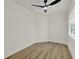 An airy bedroom featuring sleek hardwood floors, a contemporary ceiling fan, and a closet at 324 James Pl, St Cloud, FL 34769