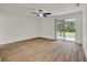 Bright bedroom with hardwood floors and glass sliding doors that provide ample natural light at 324 James Pl, St Cloud, FL 34769