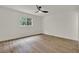 Clean and bright bedroom features wood-look floors and a modern ceiling fan at 324 James Pl, St Cloud, FL 34769