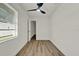 Bedroom boasts wood-look flooring, a modern ceiling fan, and ample natural light at 324 James Pl, St Cloud, FL 34769